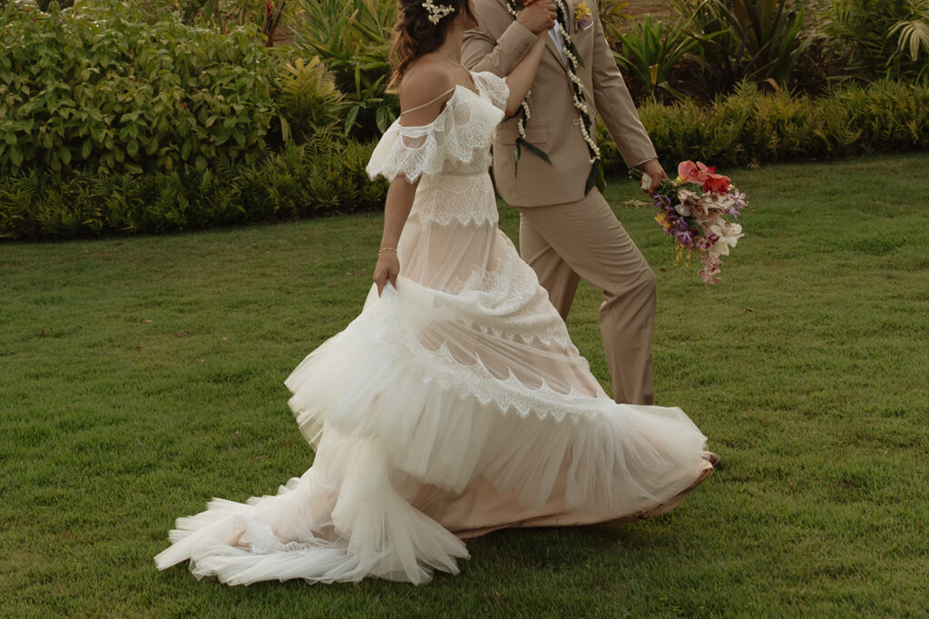 Bride holding tropical bouquet at an Oahu destination wedding - photographer